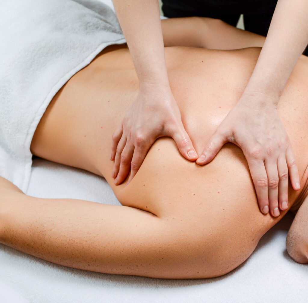 Therapist massaging shoulder muscles during Ayurvedic massage